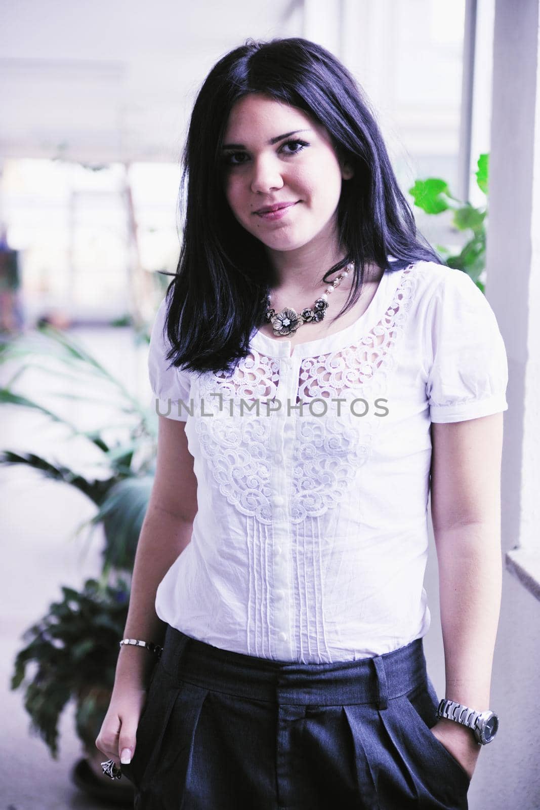 young happy business woman or student posing in fashionable clothes indoor in bright building 