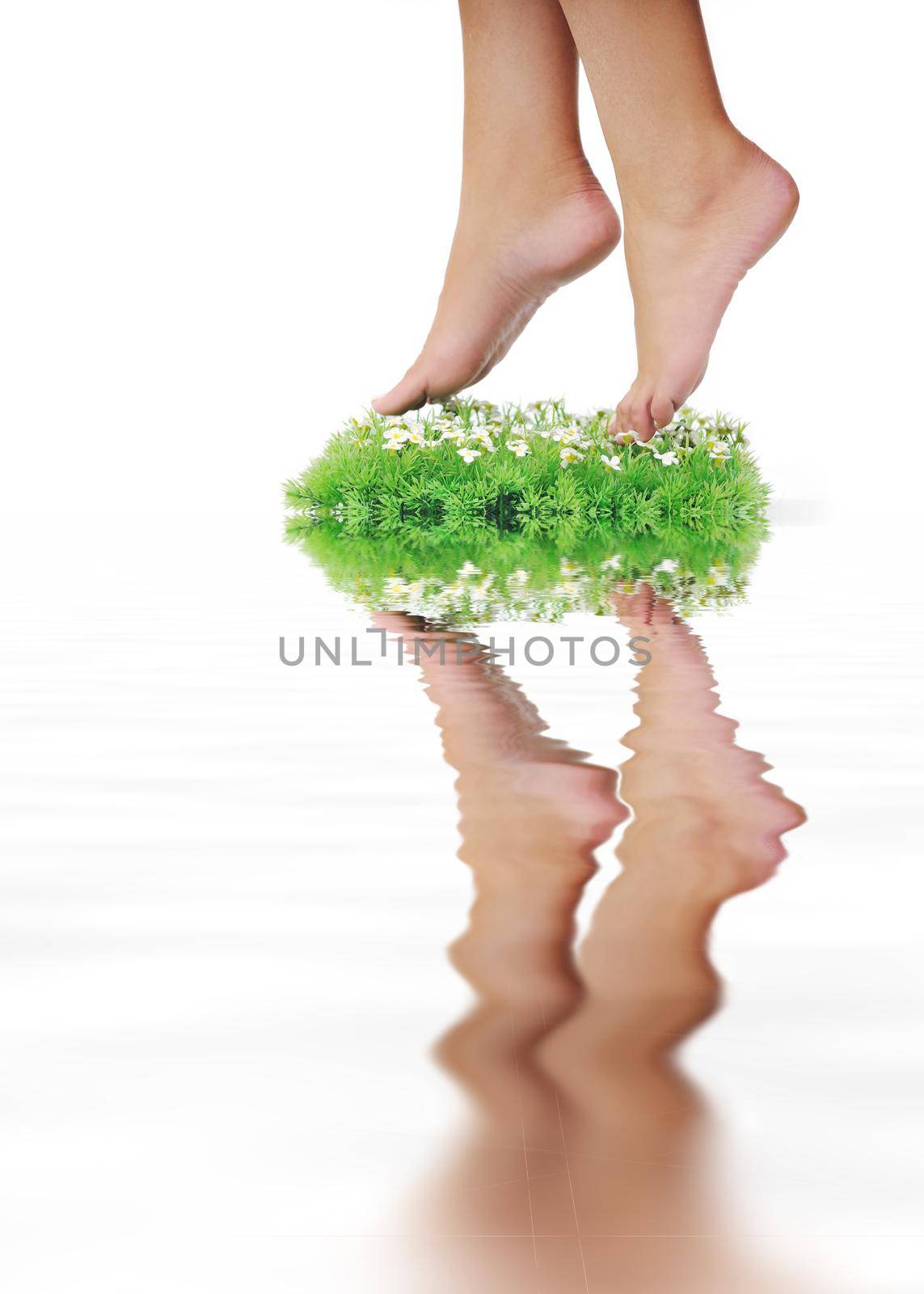 woman legs walking on small peace of green grass isolated on white representing last oasis concept