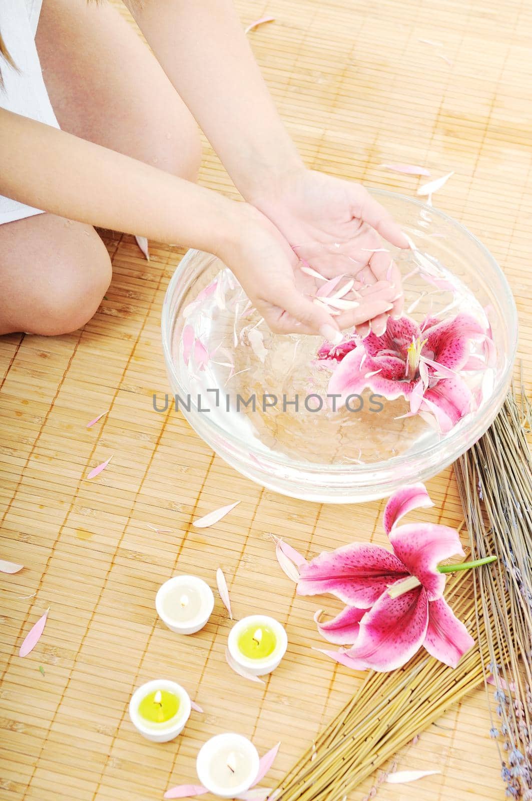 hand  and nail spa and beauty treatment with aroma and flowers in water isolated on white