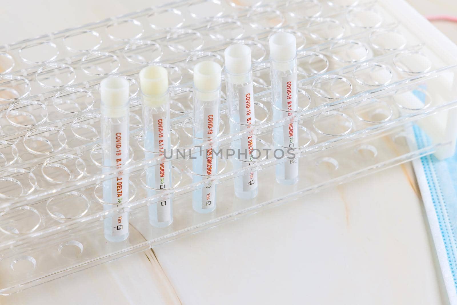 Tube containing a swab sample for COVID-19 that has tested positive with testing for presence of new version Omicron of coronavirus