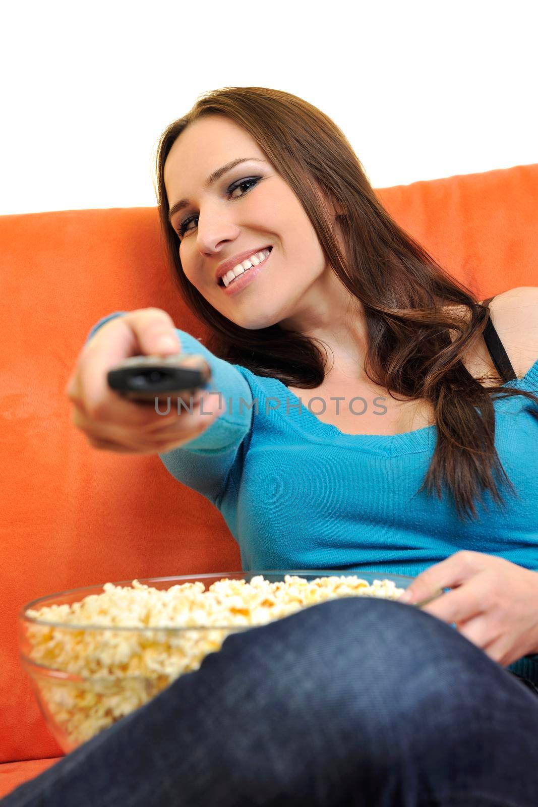 young woman eat popcorn and watching tv by dotshock