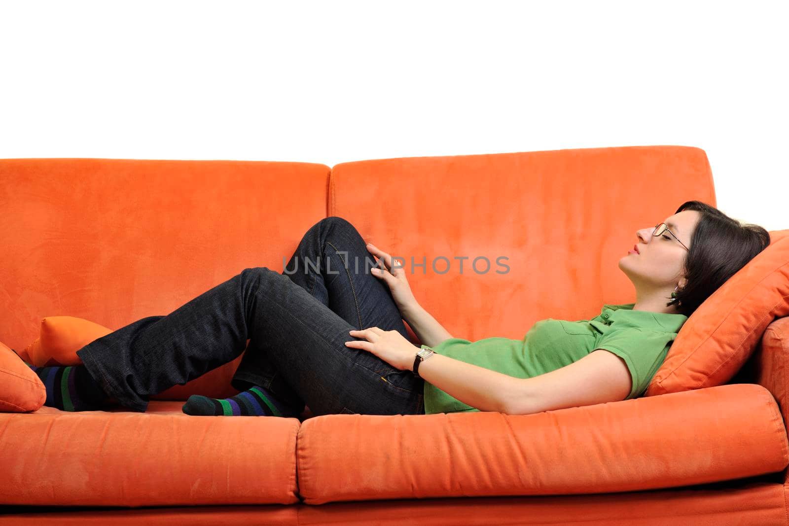 happy young woman relax on orange sofa  at home isolated on white background in studio