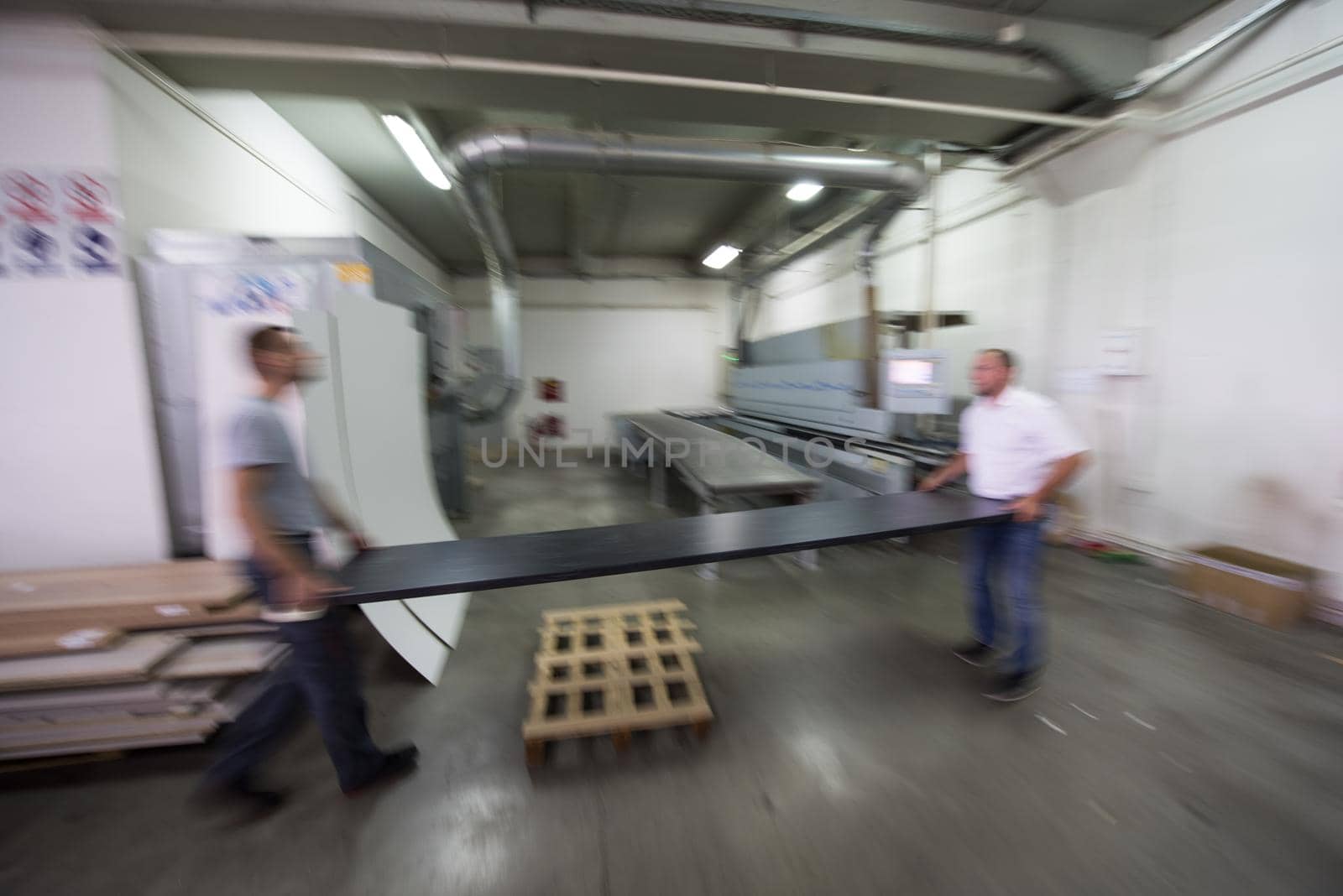 two worker working in a factory for the production of wooden furniture