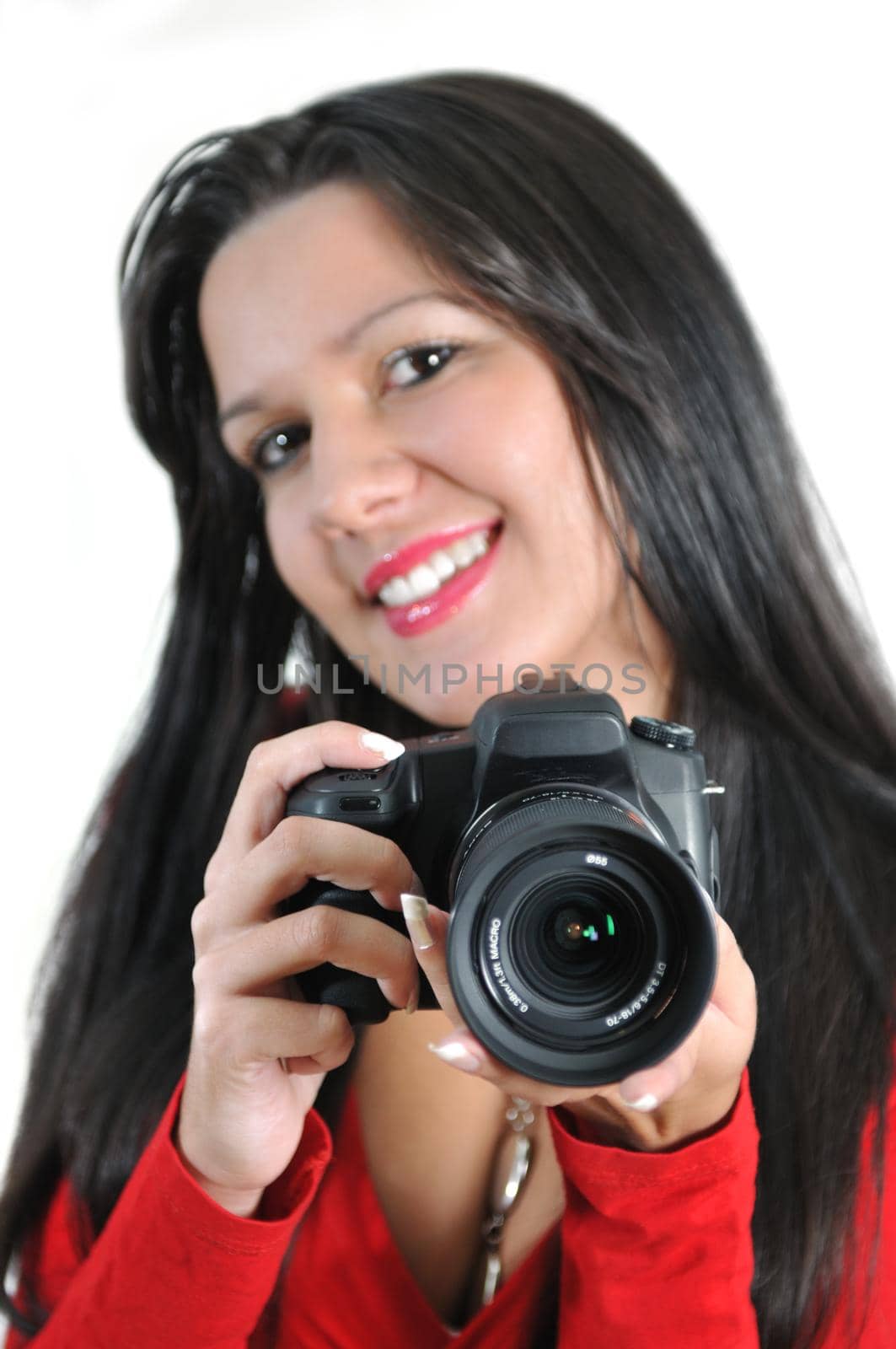 Young woman holding camera in hand taking picture isolated