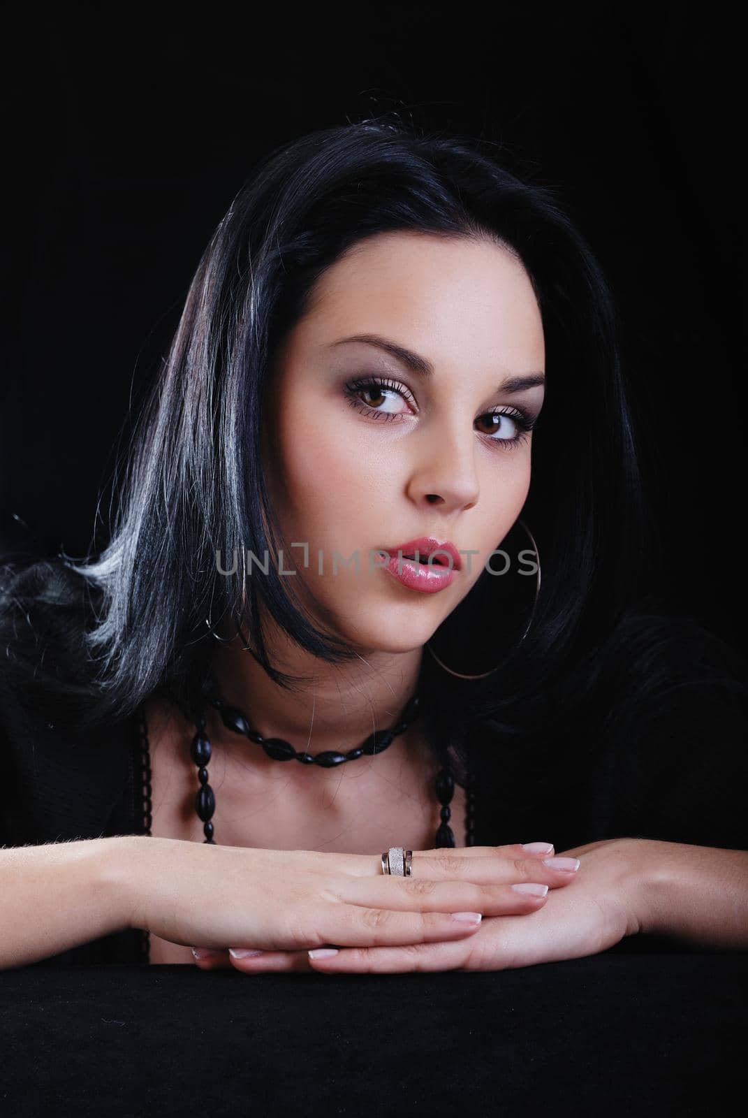 one young beautiful brunette  woman in black posing in studio