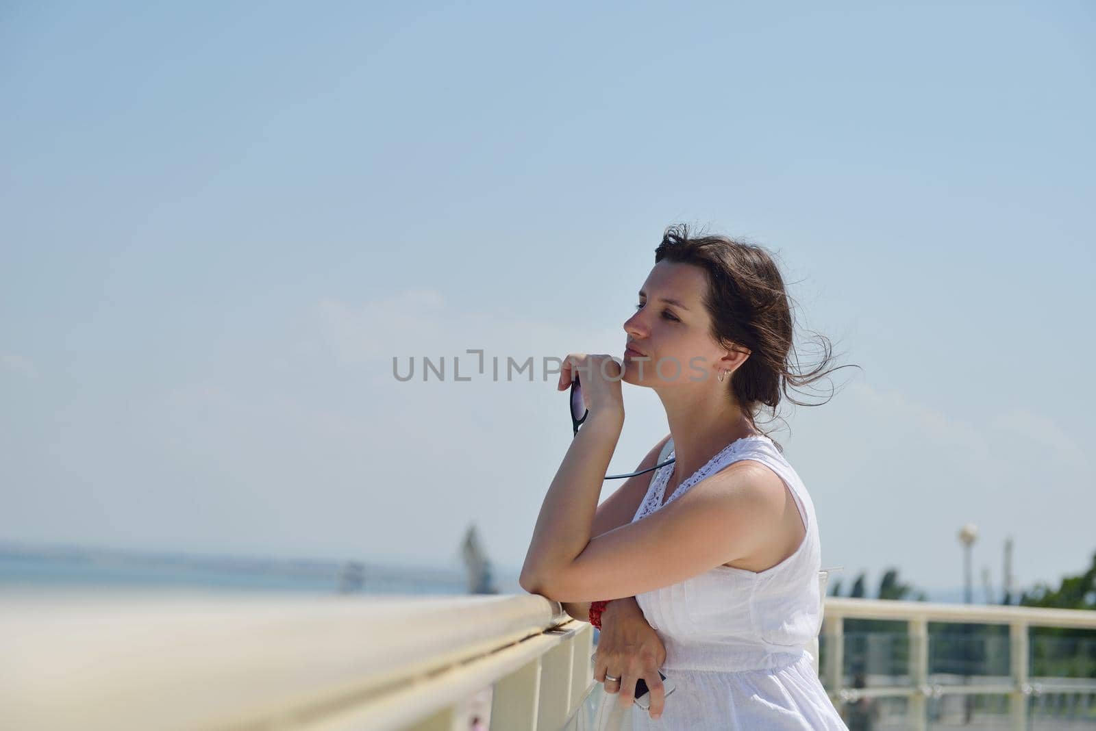 happy young tourist woman have fun while traveling araund city with blue sky and sea in background