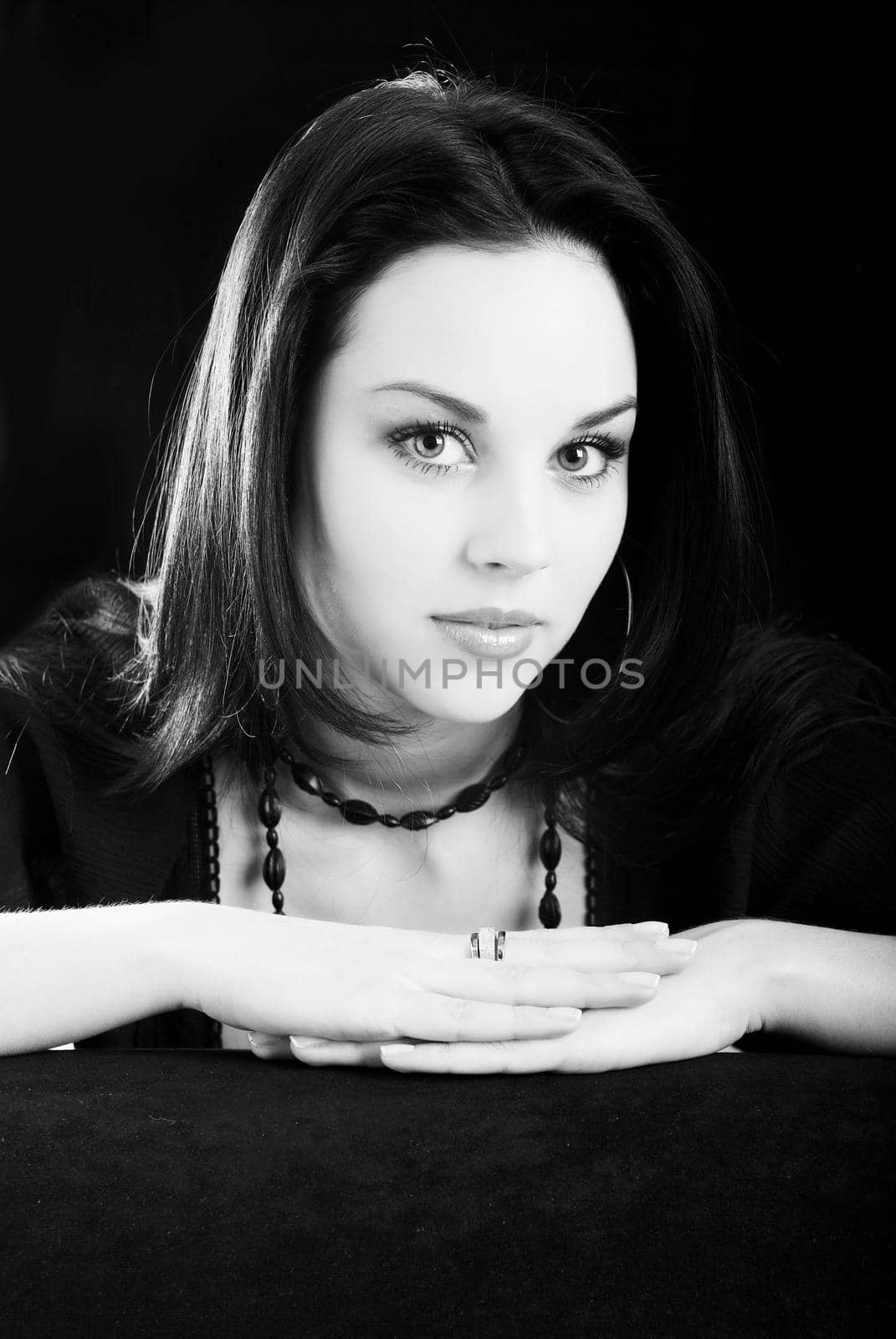 one young beautiful brunette  woman in black posing in studio