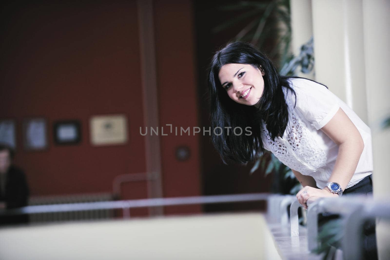 young happy business woman or student posing in fashionable clothes indoor in bright building 
