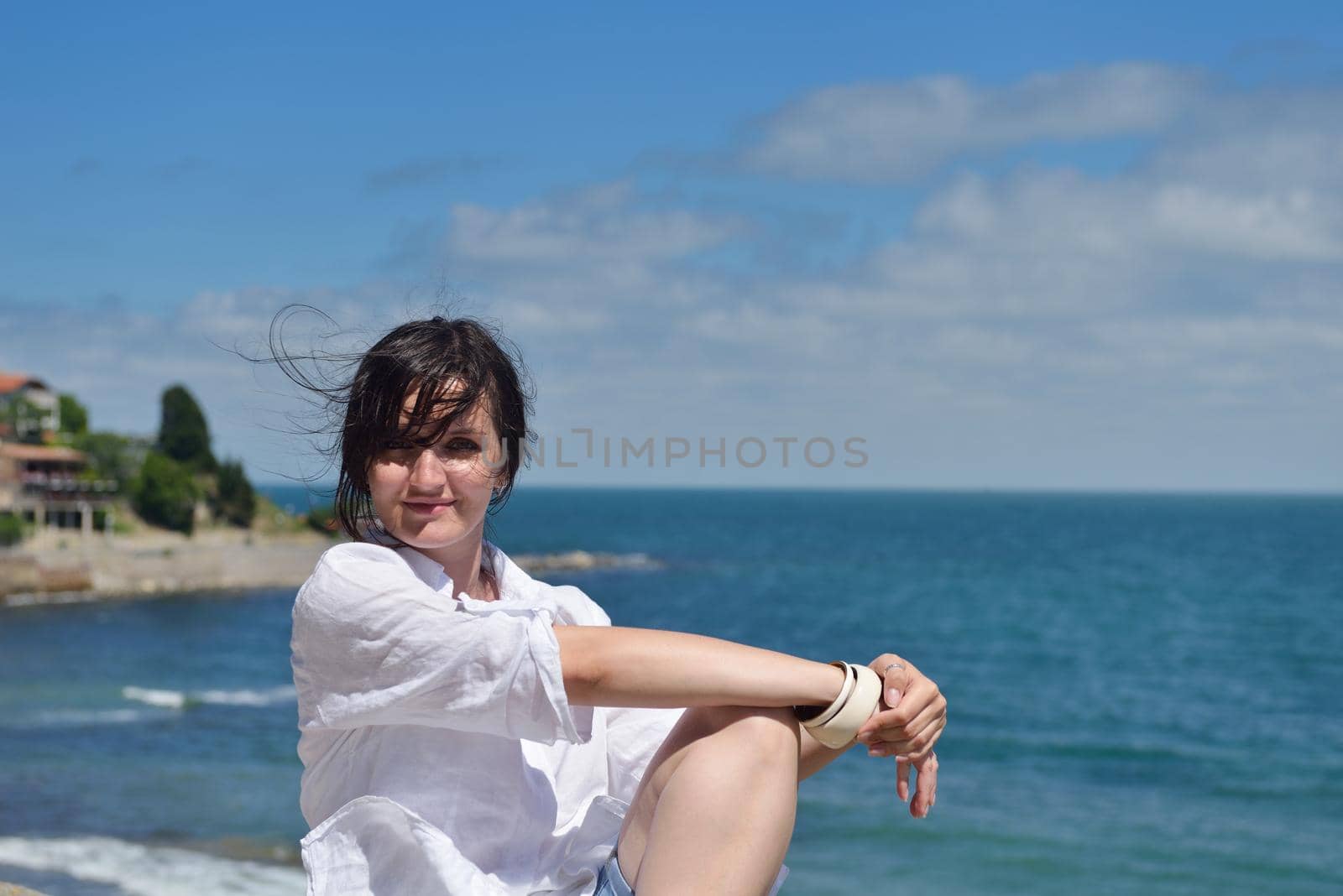 happy young tourist woman have fun while traveling araund city with blue sky and sea in background