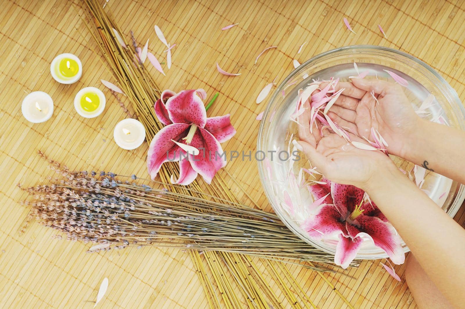 hand spa and beauty treatment with aroma and flowers in water