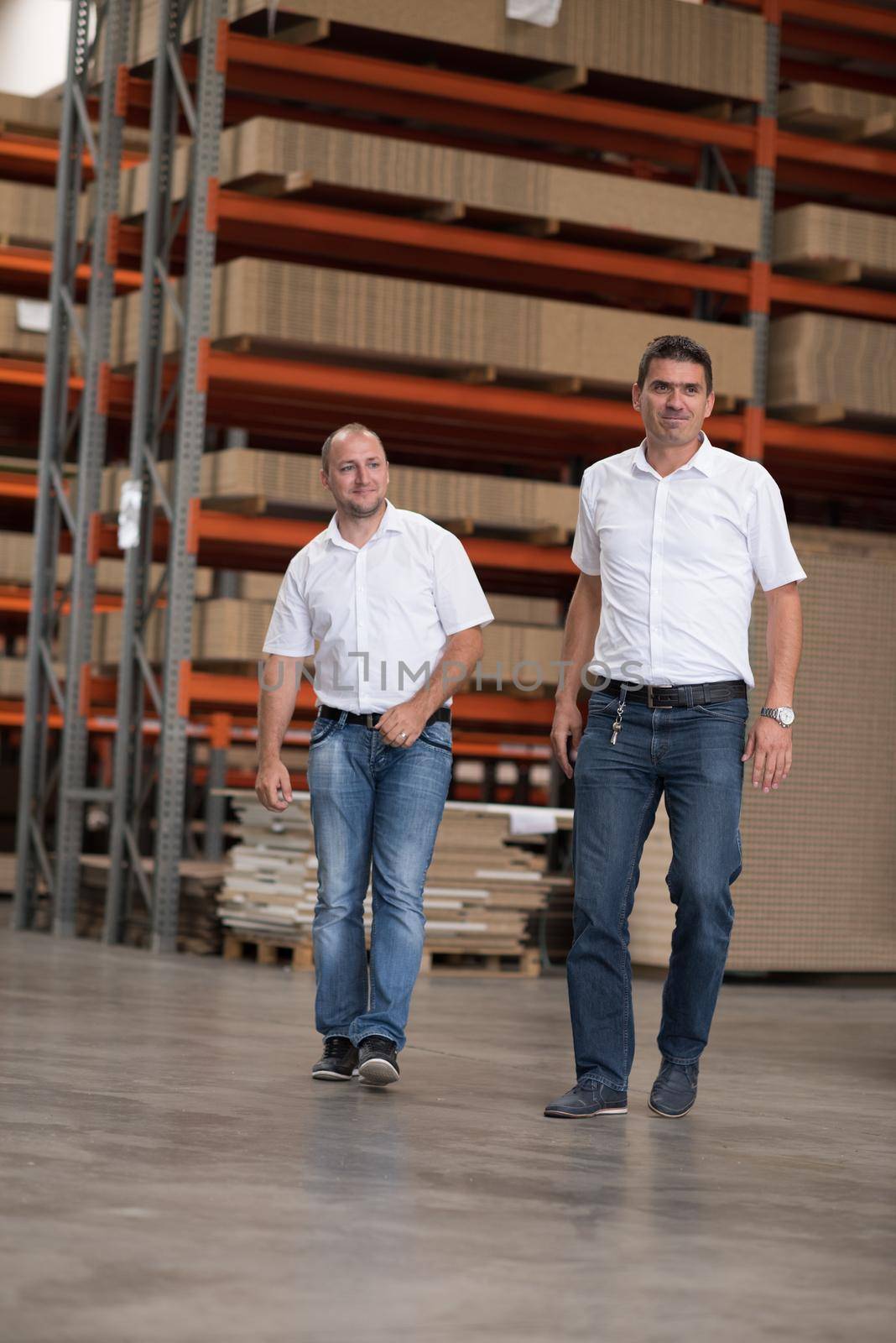 Portrait of independent designers in their furniture manufacturing workshop, looking relaxed and confident