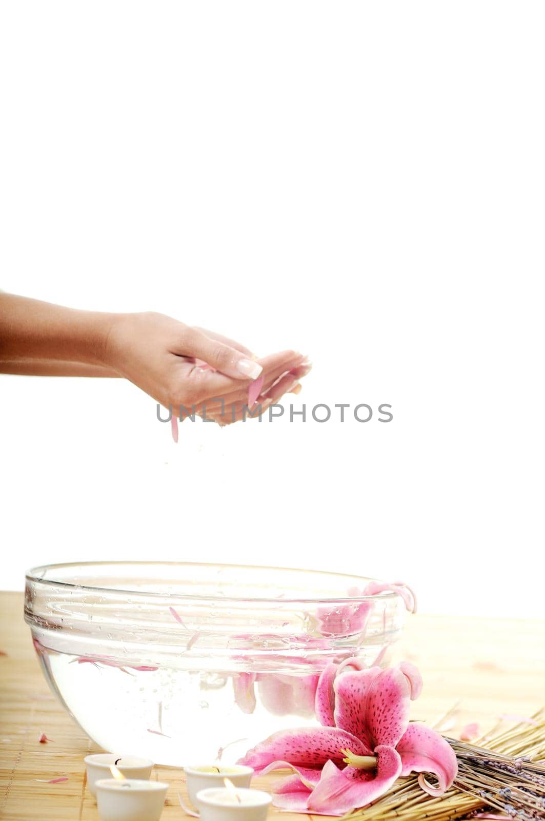 hand  and nail spa and beauty treatment with aroma and flowers in water isolated on white