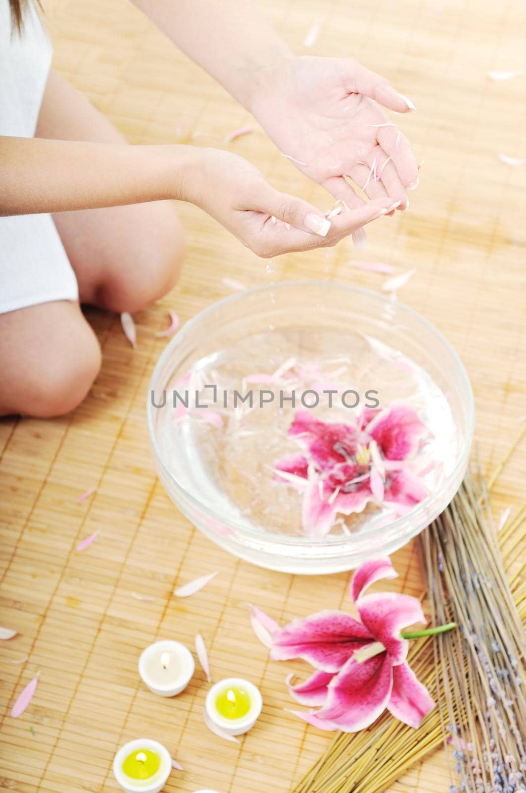 hand  and nail spa and beauty treatment with aroma and flowers in water isolated on white