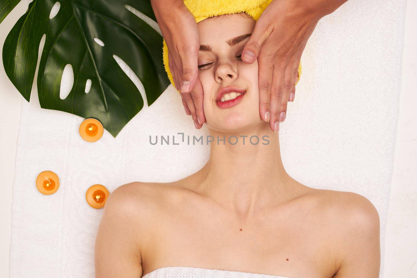 attractive woman with a towel on my head skin care light background. High quality photo