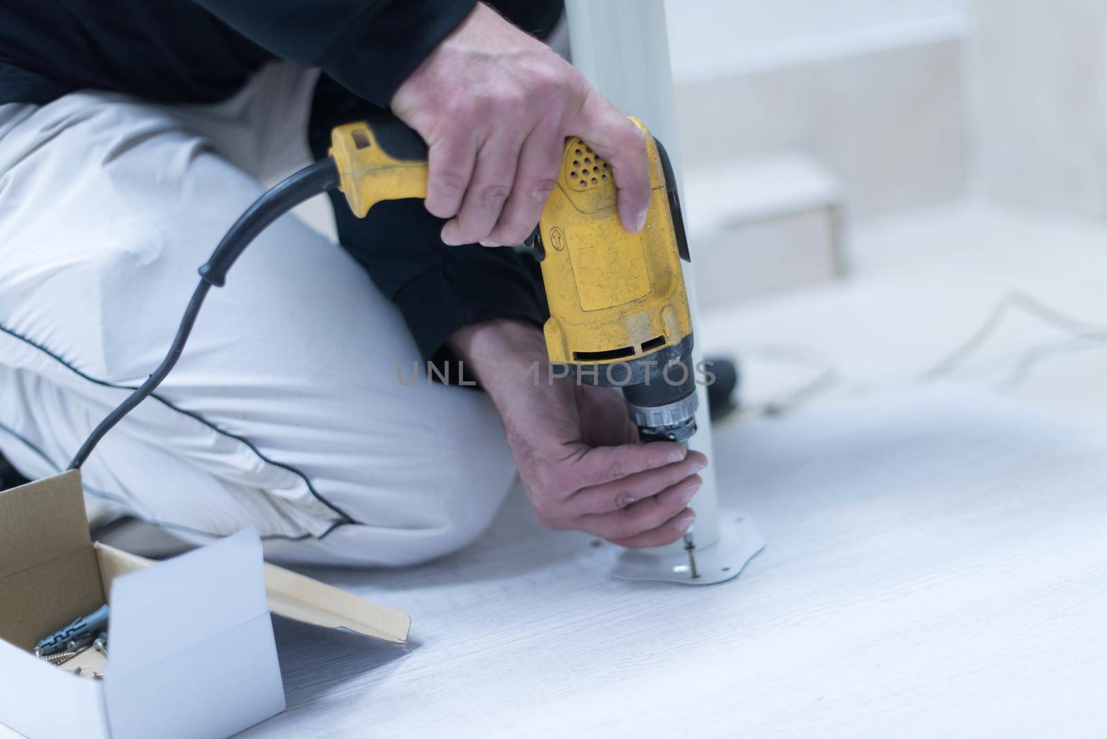 repairman working with drilling machine by dotshock