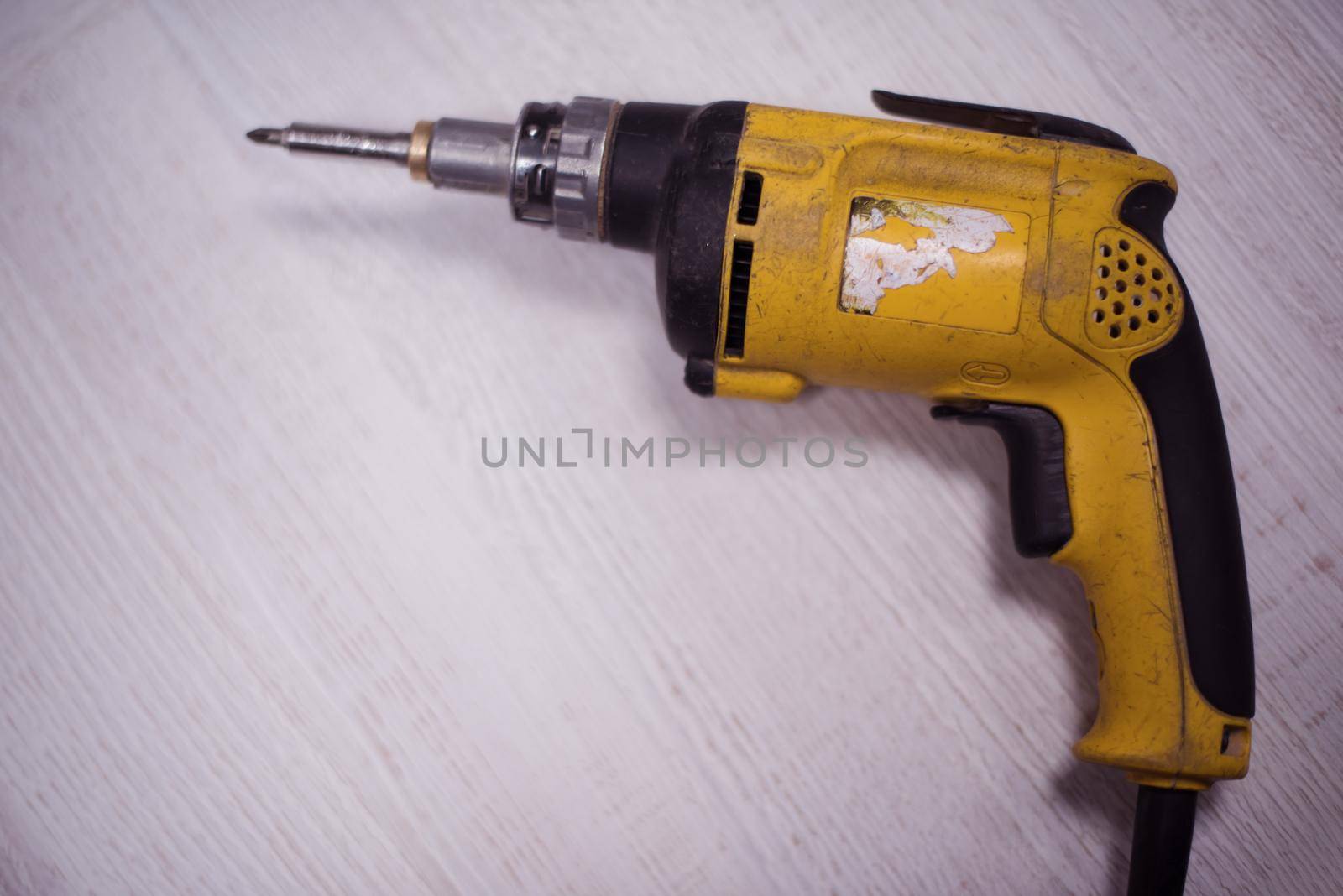 drill machine isolated on white old retro wood background