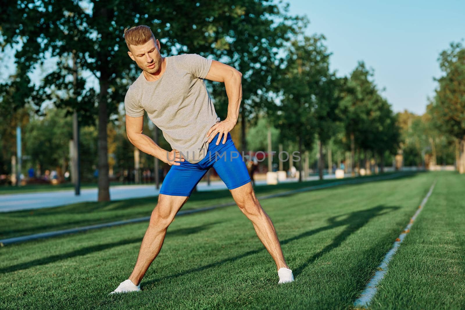 sporty man in the park on the lawn exercise lifestyle. High quality photo