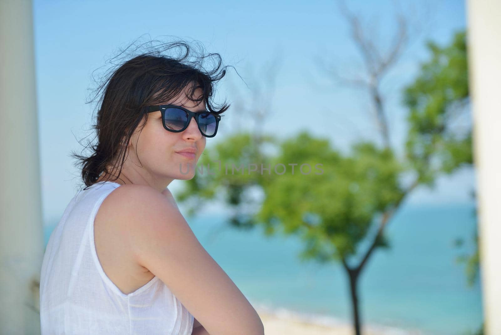 happy young tourist woman have fun while traveling araund city with blue sky and sea in background