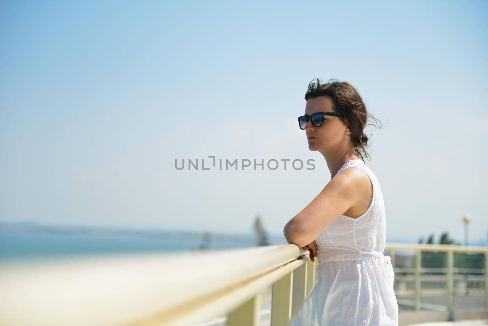 happy young tourist woman have fun while traveling araund city with blue sky and sea in background