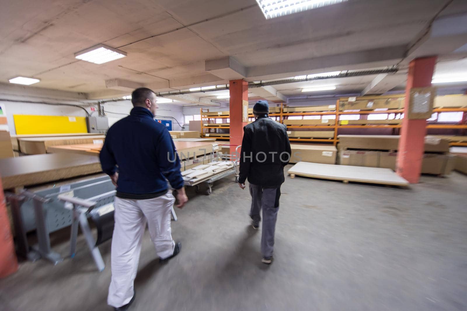 two young carpenters working together in big modern carpentry High quality wood concept