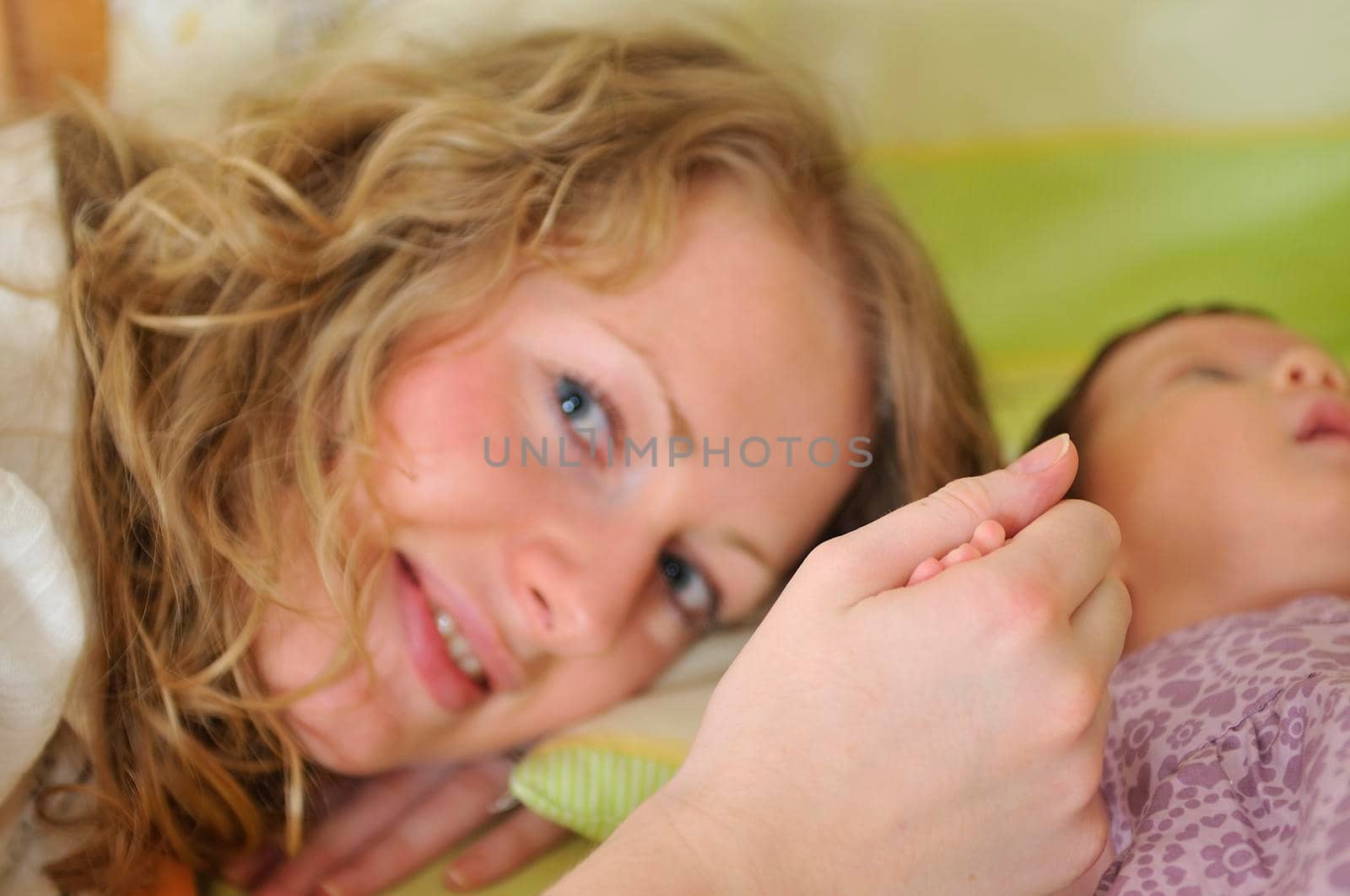 beautiful young mother hold small children hand