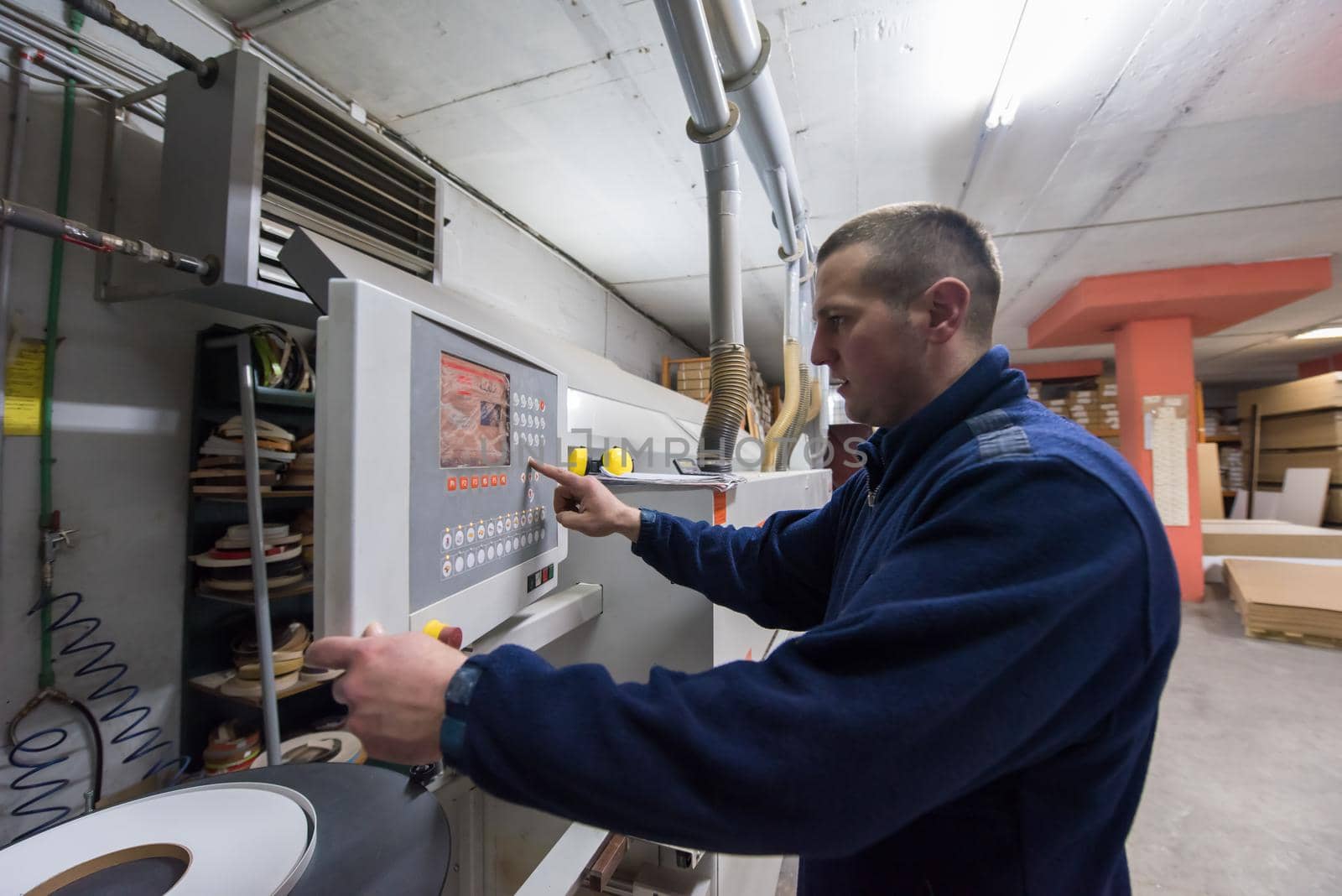 carpenter calculating and programming a cnc wood working machine by dotshock