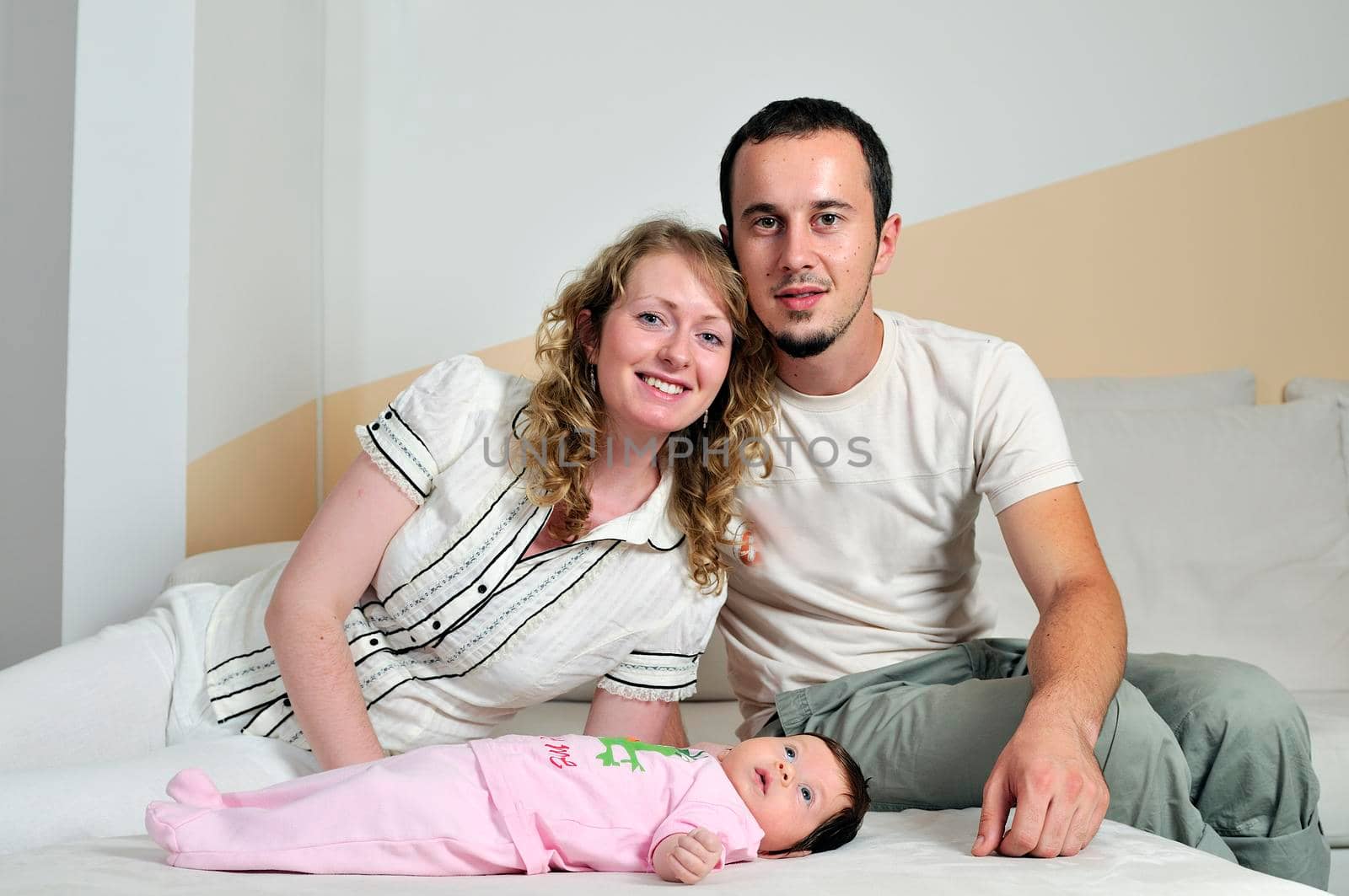 indoor portrait with happy young famil and  cute little babby  by dotshock