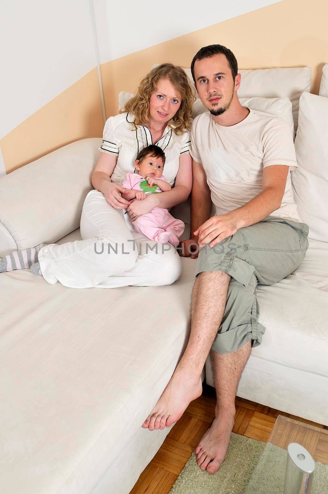 indoor portrait with happy young family and  cute little babby  by dotshock
