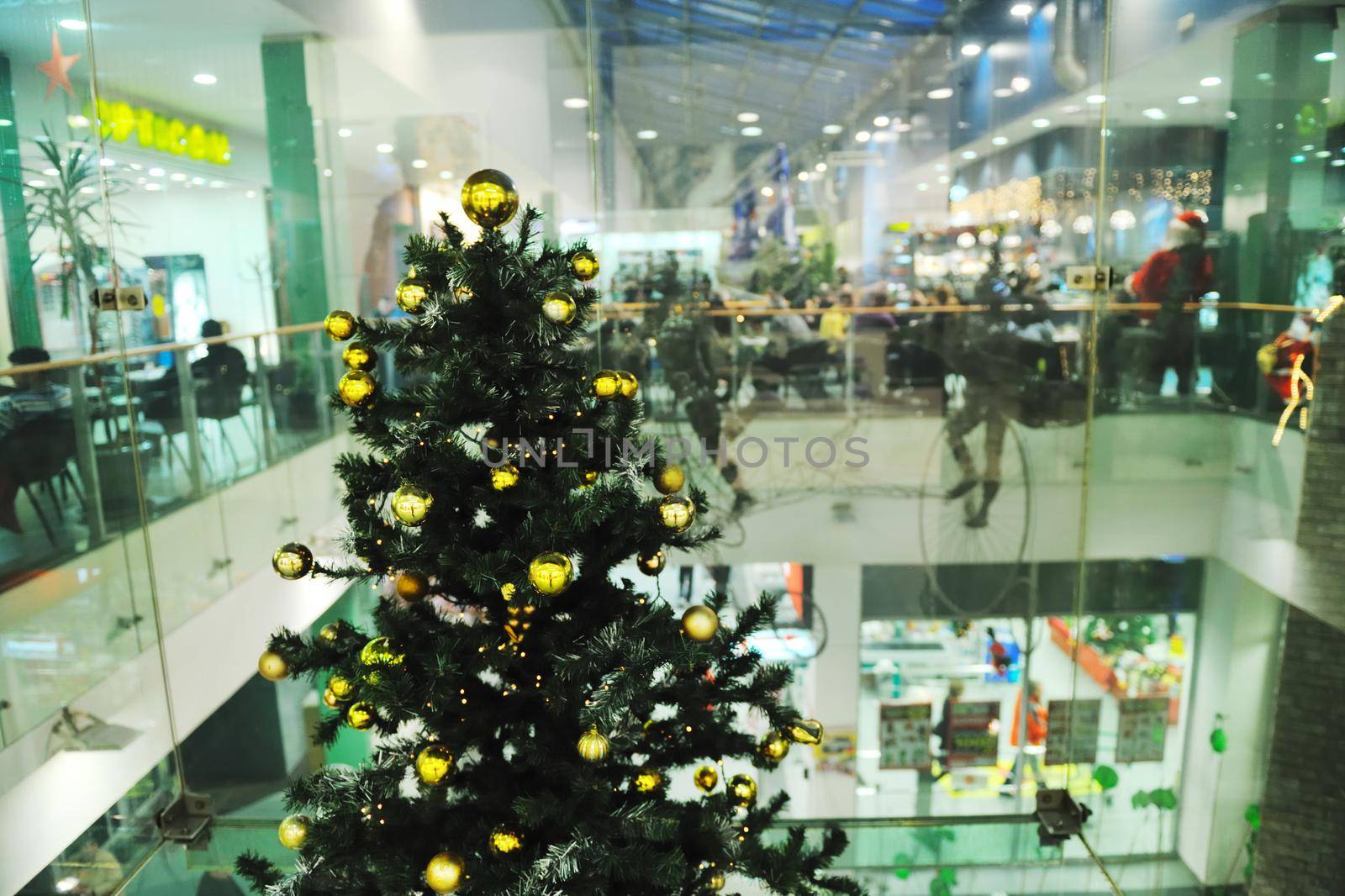 xmas tree decoration closeup with blured lights in shopping centre in backgroun