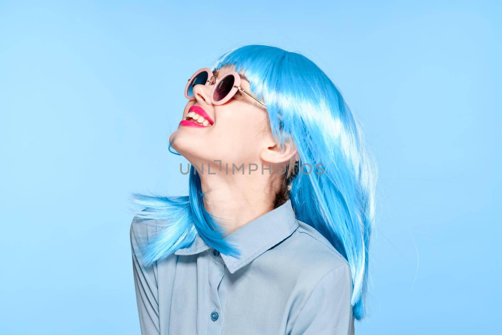 cheerful woman wearing sunglasses blue wig glamor model. High quality photo