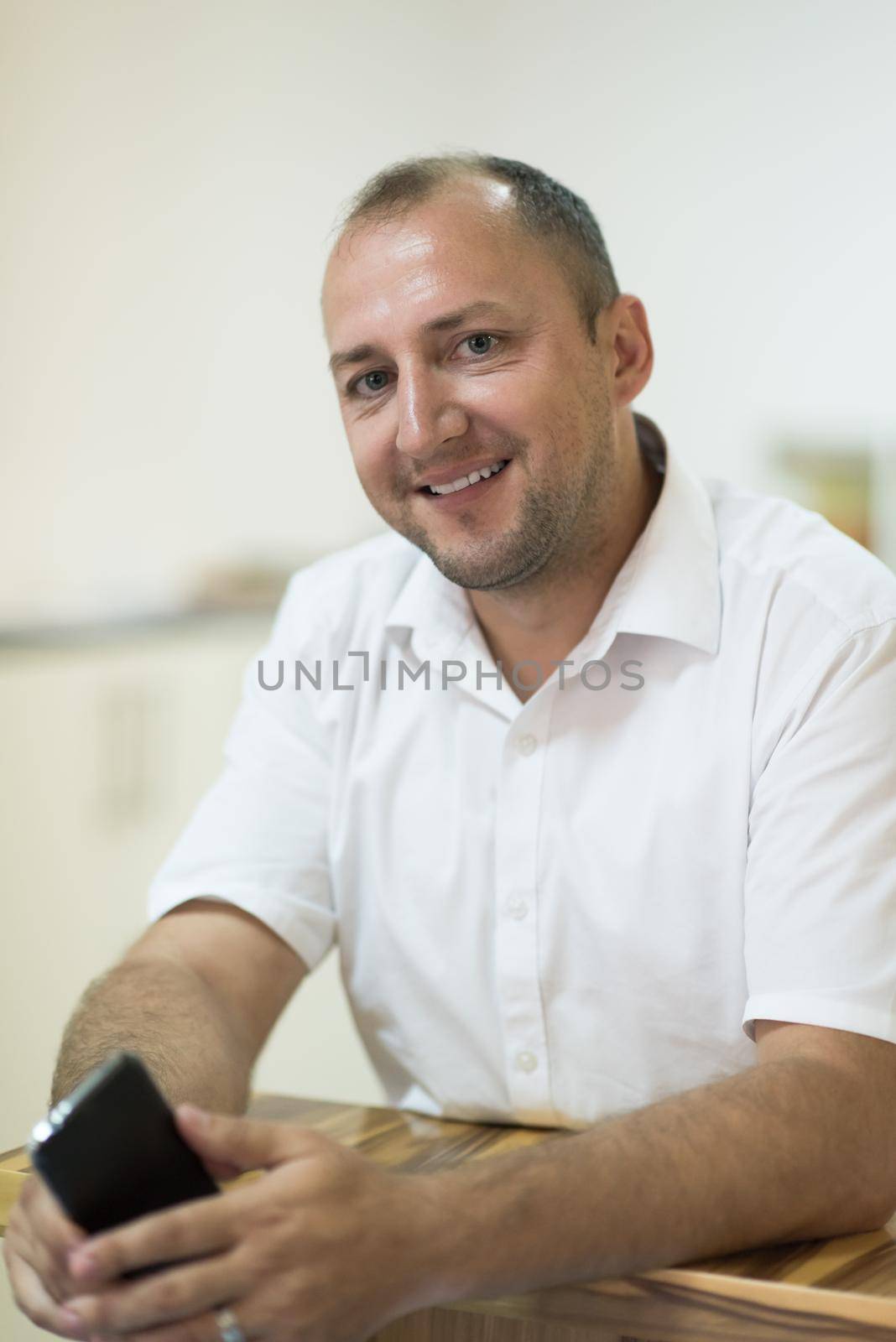 designer in his furniture manufacturing workshop by dotshock