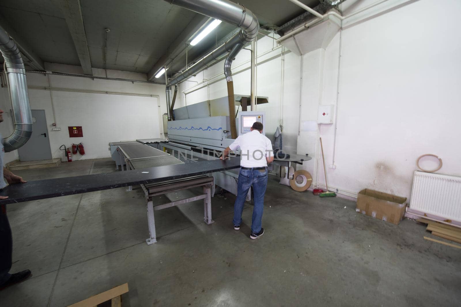 two worker working in a factory for the production of wooden furniture