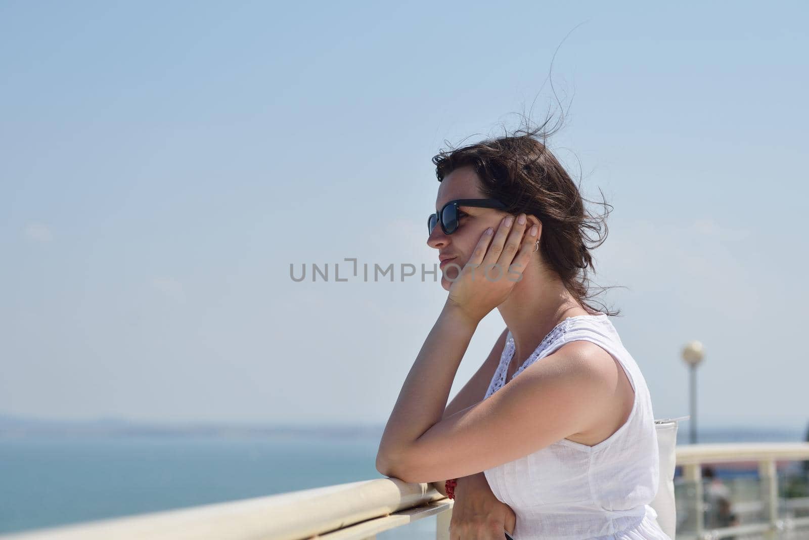 Happy  young woman with spreading arms, blue sky with clouds in background  - copyspace