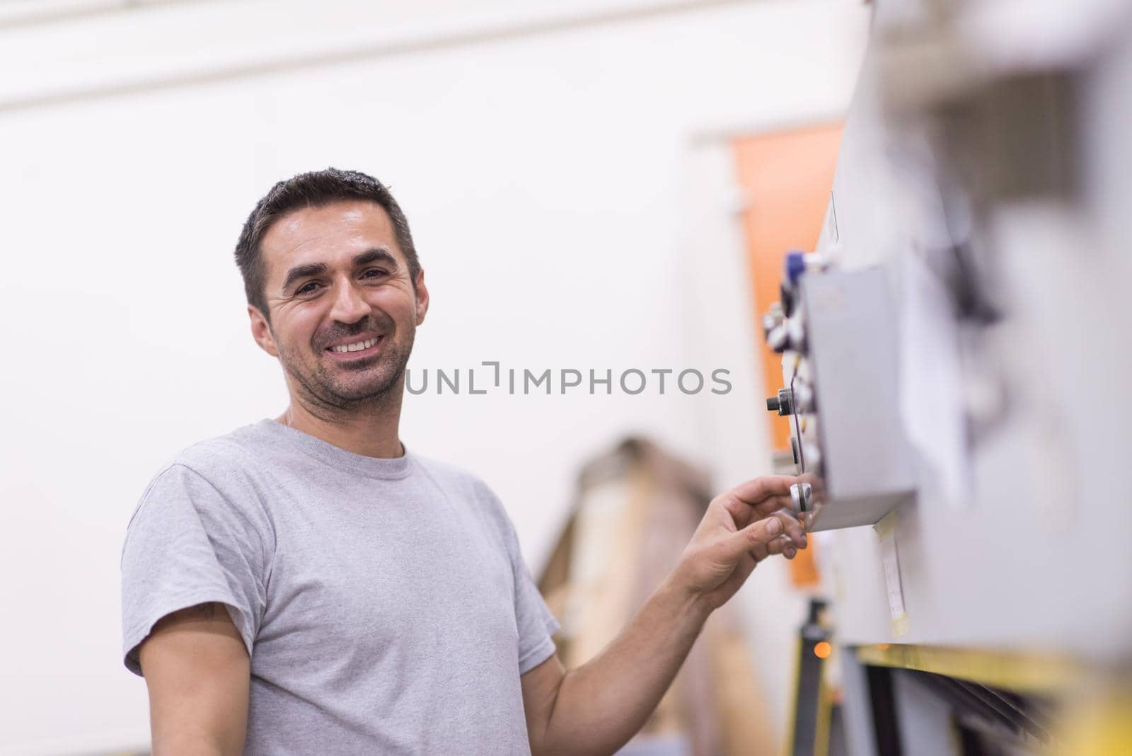 worker in a factory of wooden furniture by dotshock