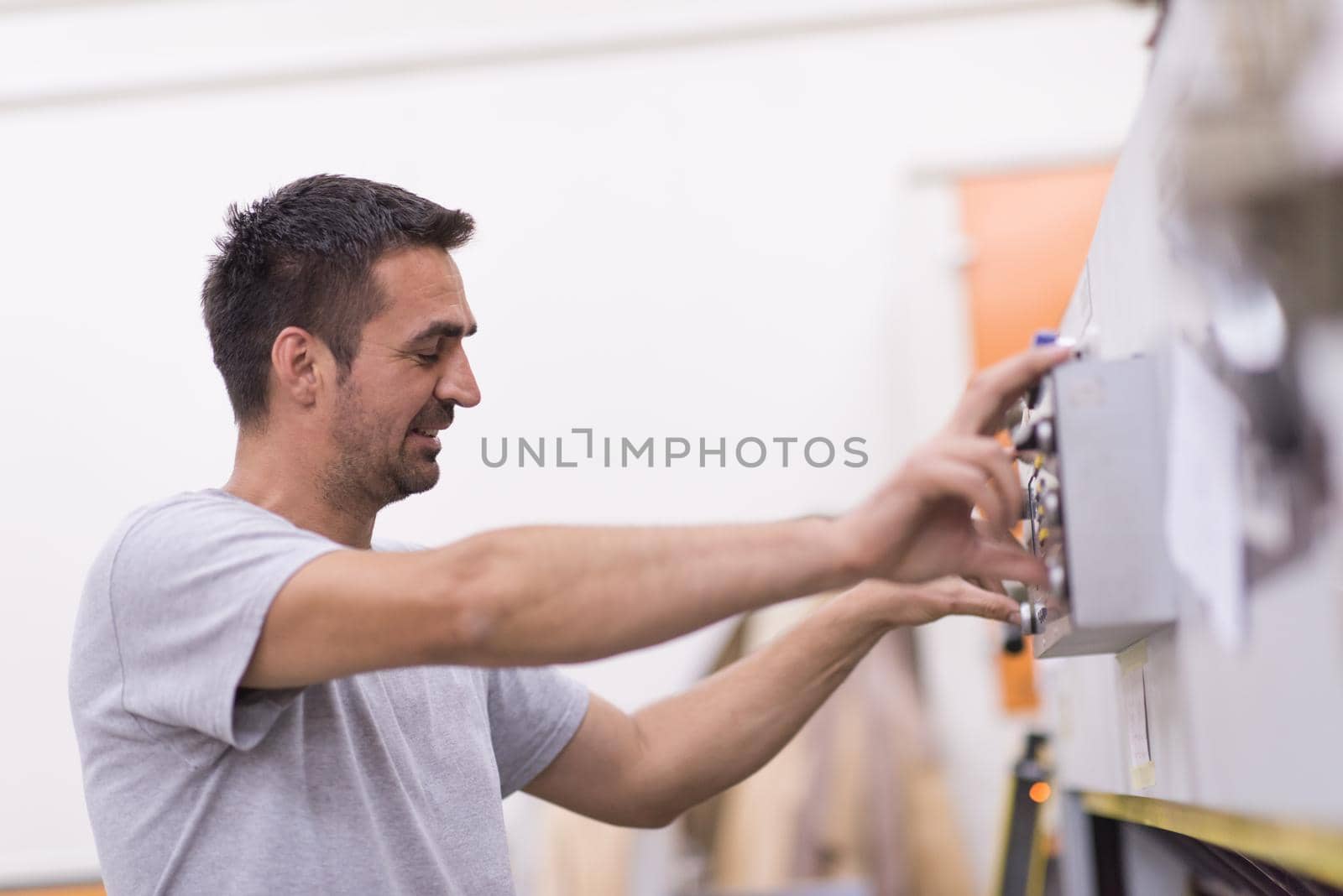 worker in a factory of wooden furniture by dotshock