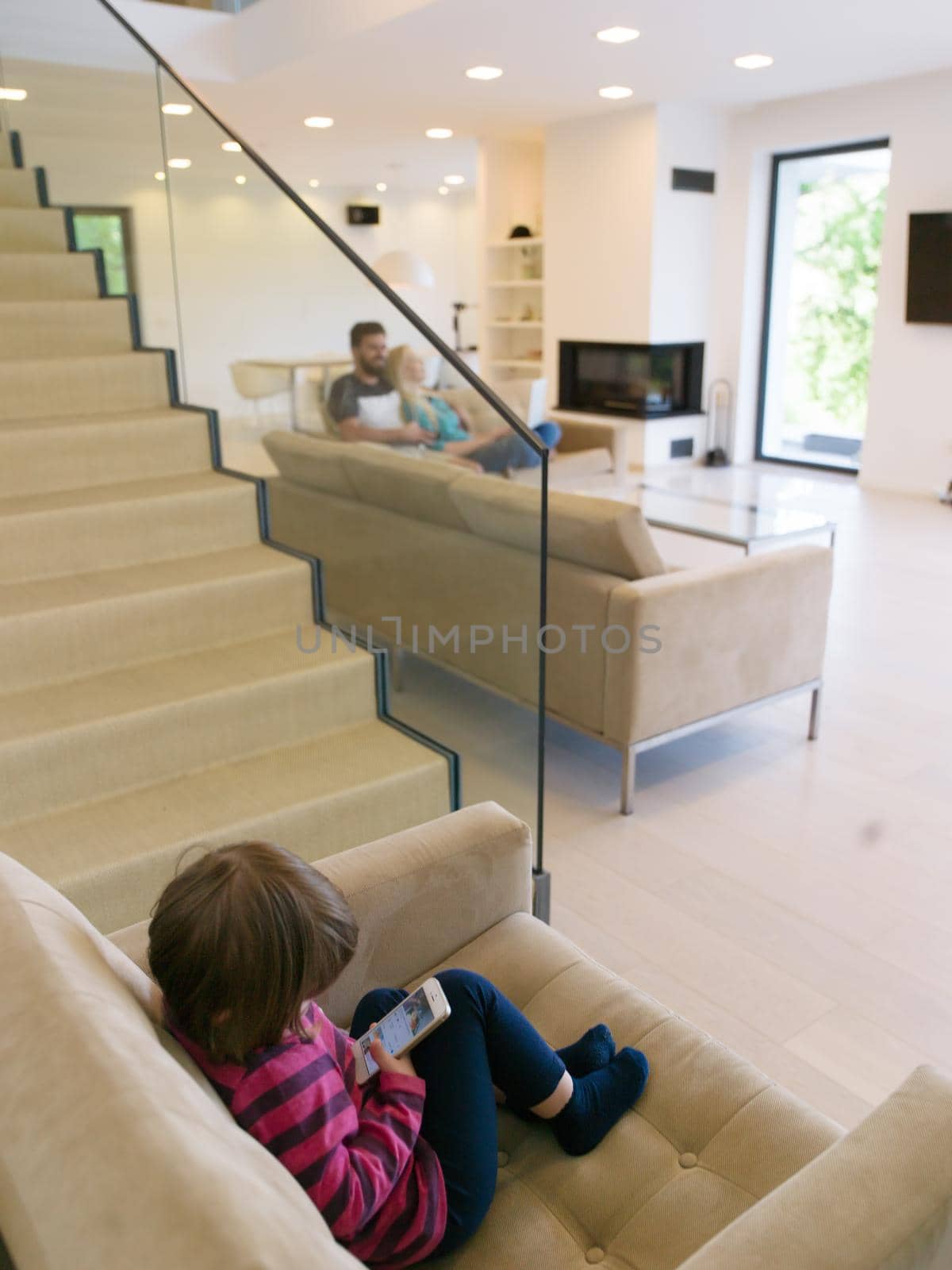 family with little girl enjoys in the modern living room by dotshock