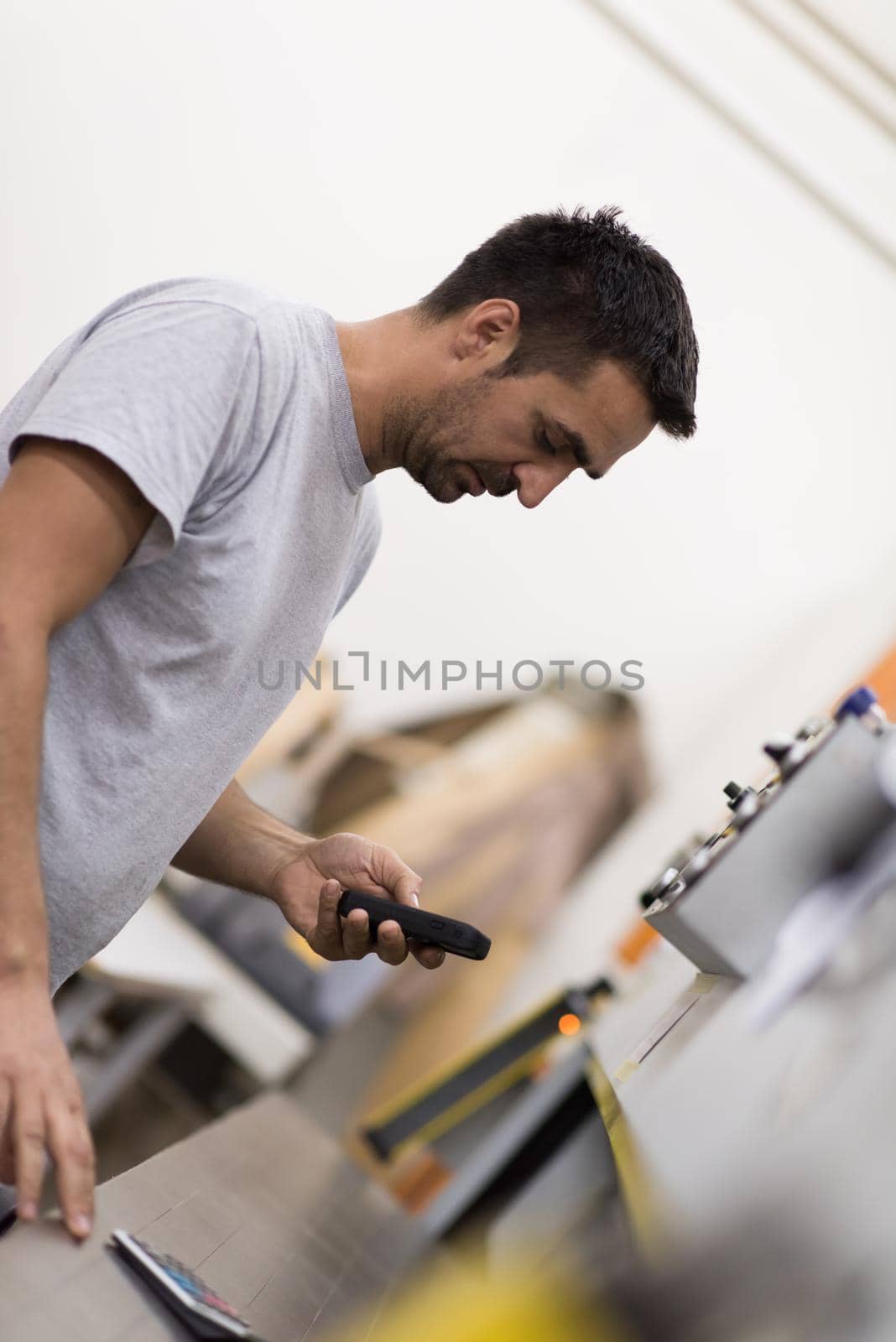engineer in front of wood cutting machine by dotshock