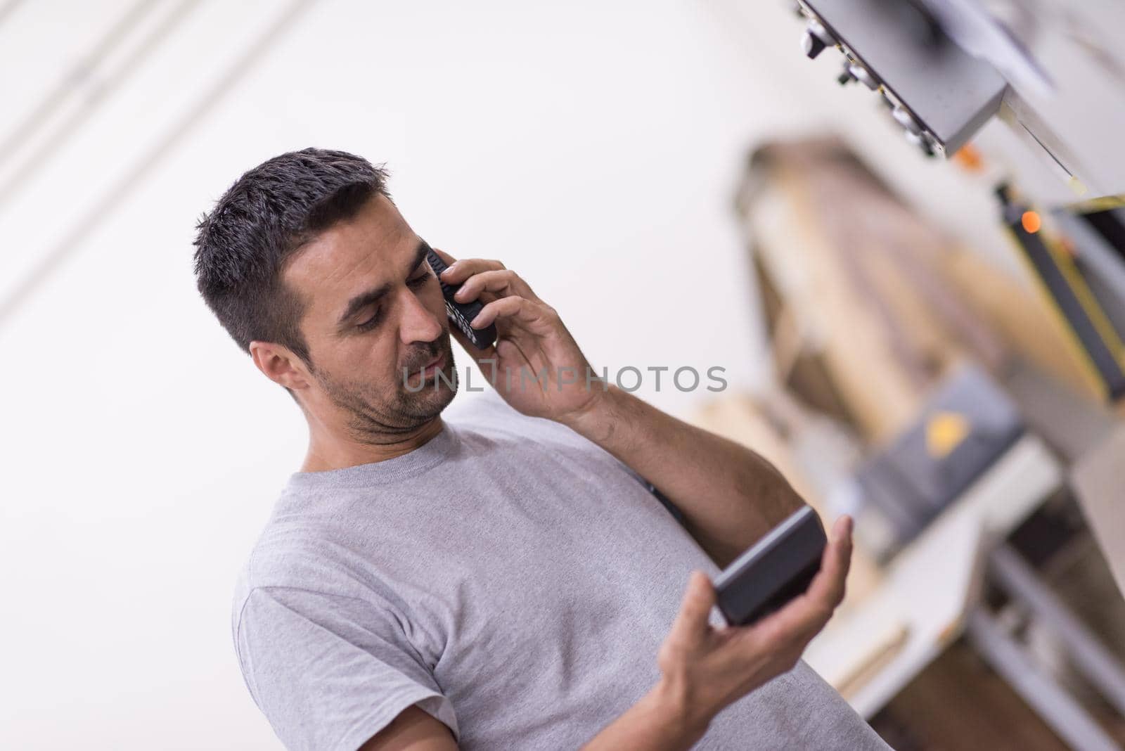 engineer in front of wood cutting machine by dotshock