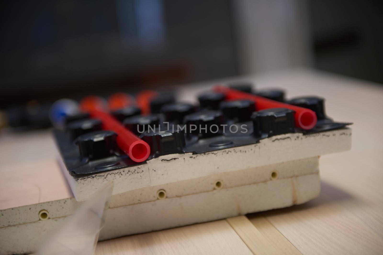 Black underfloor heating posed in a under construction building