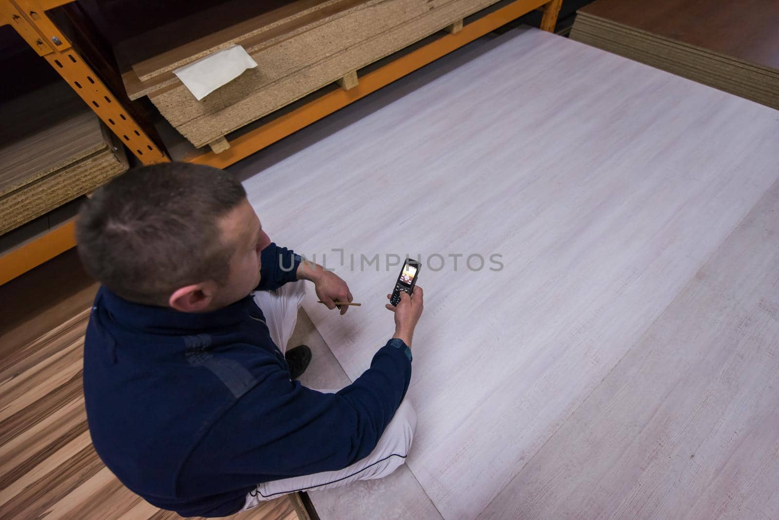 carpenter using a mobile phone to calculate measures by dotshock