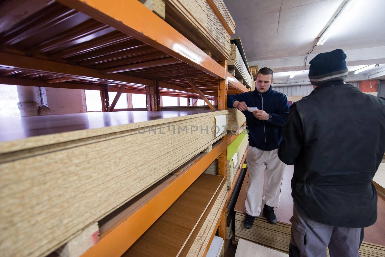 two young carpenters working in big modern carpentry by dotshock