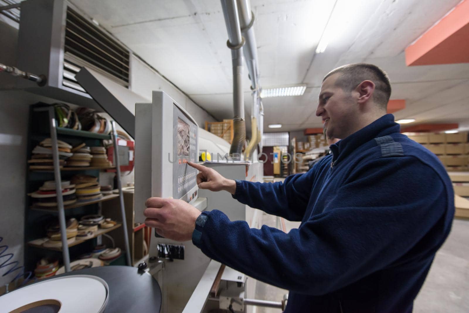 carpenter calculating and programming a cnc wood working machine by dotshock