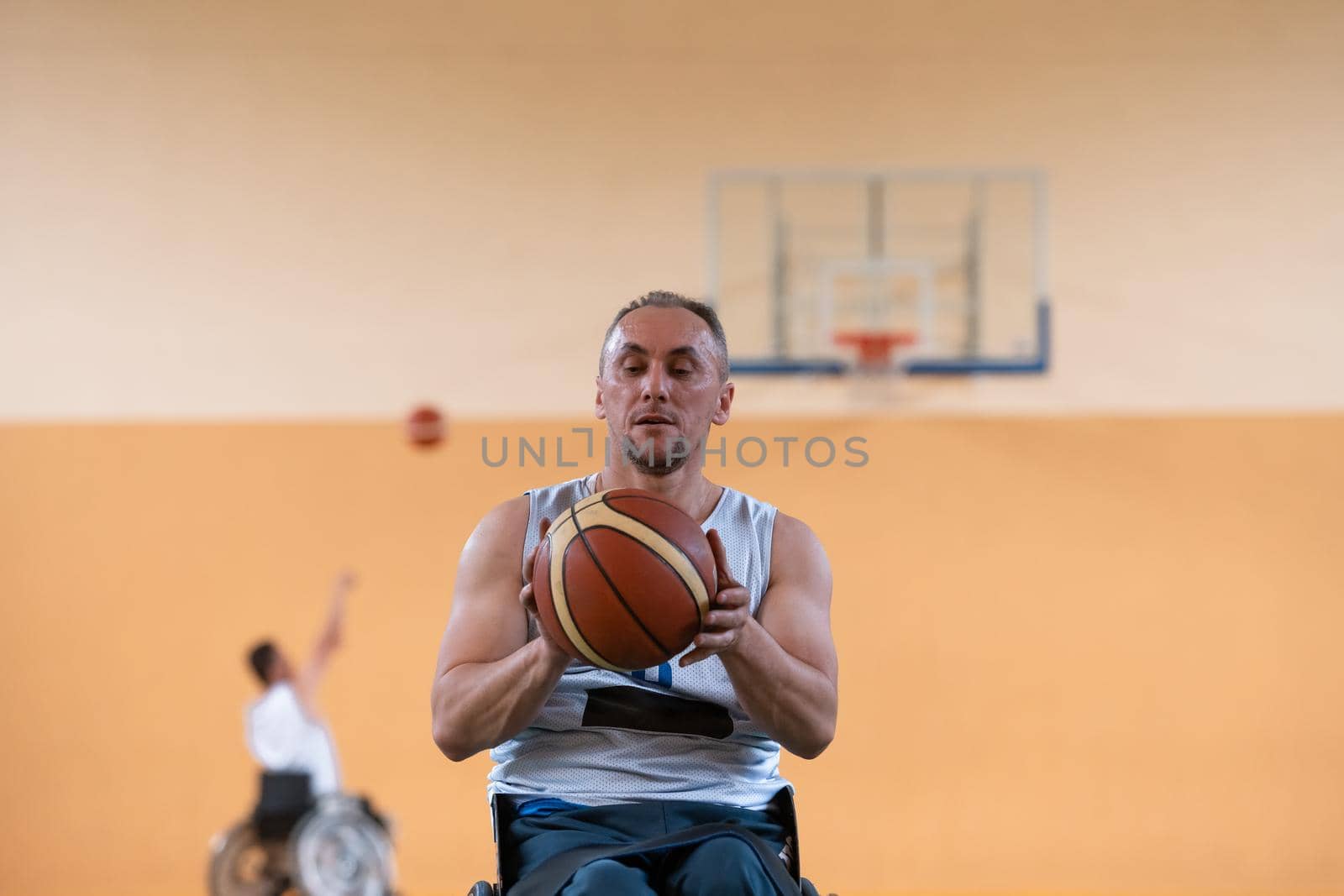 a photo of a war veteran playing basketball with a team in a modern sports arena. The concept of sport for people with disabilities by dotshock
