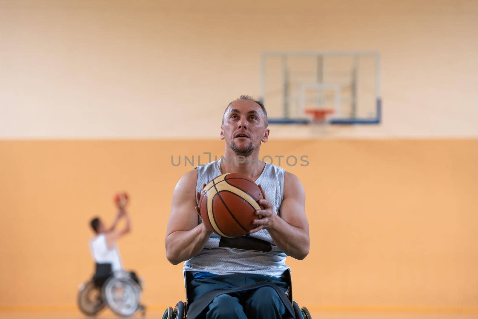 a photo of a war veteran playing basketball with a team in a modern sports arena. The concept of sport for people with disabilities. High quality photo