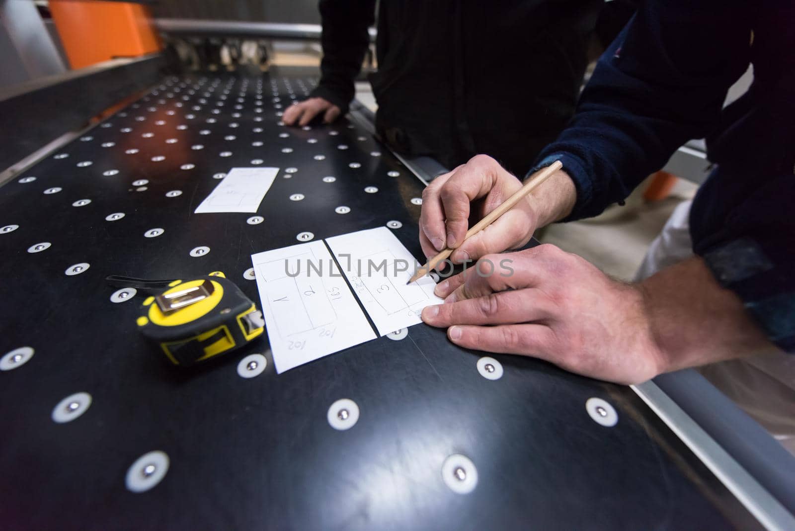 carpenters calculating and programming a cnc wood working machine by dotshock