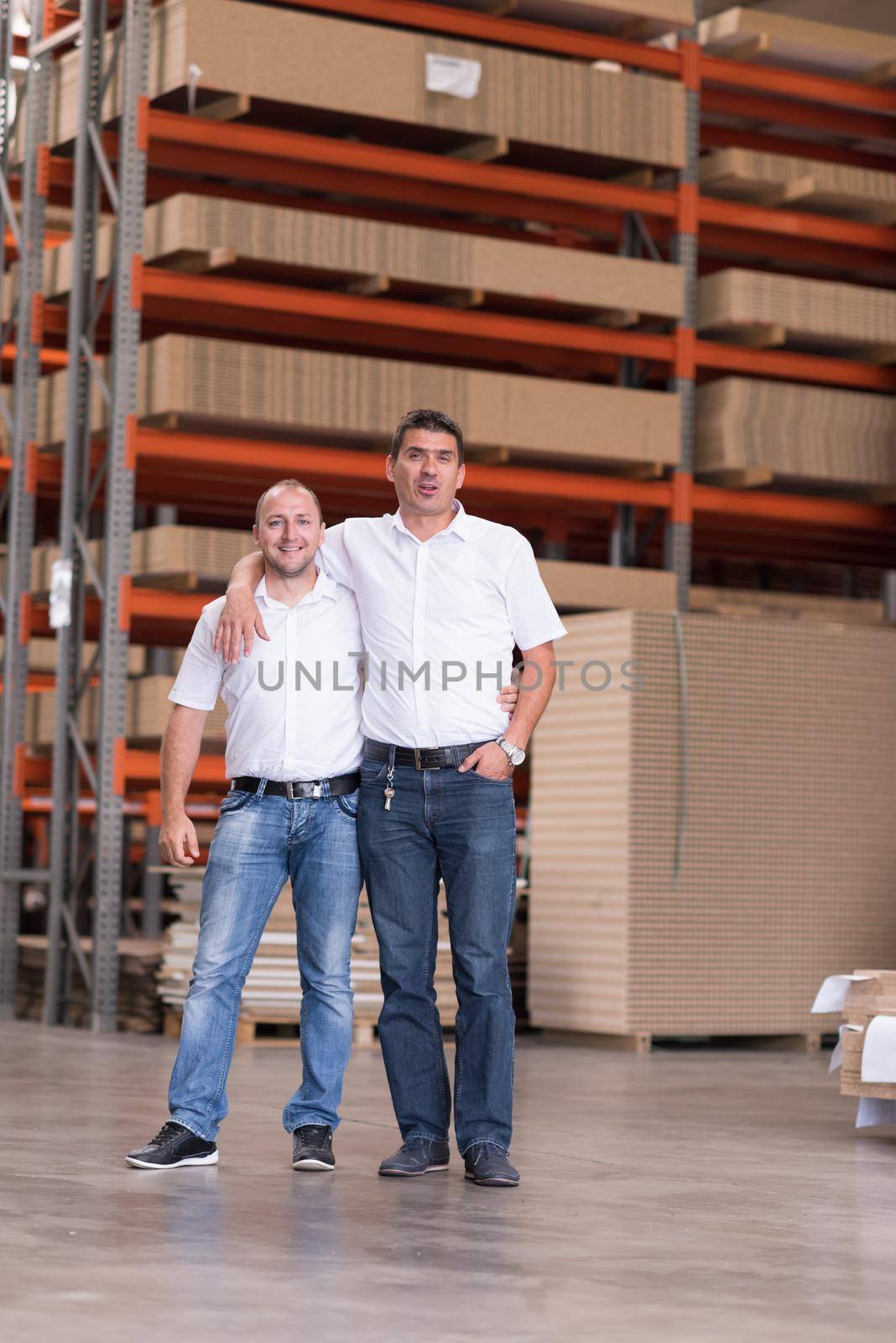 Portrait of independent designers in their furniture manufacturing workshop, looking relaxed and confident