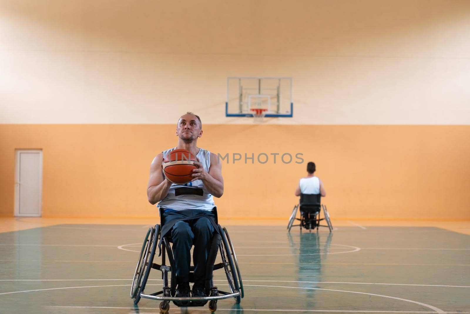 a photo of a war veteran playing basketball with a team in a modern sports arena. The concept of sport for people with disabilities by dotshock