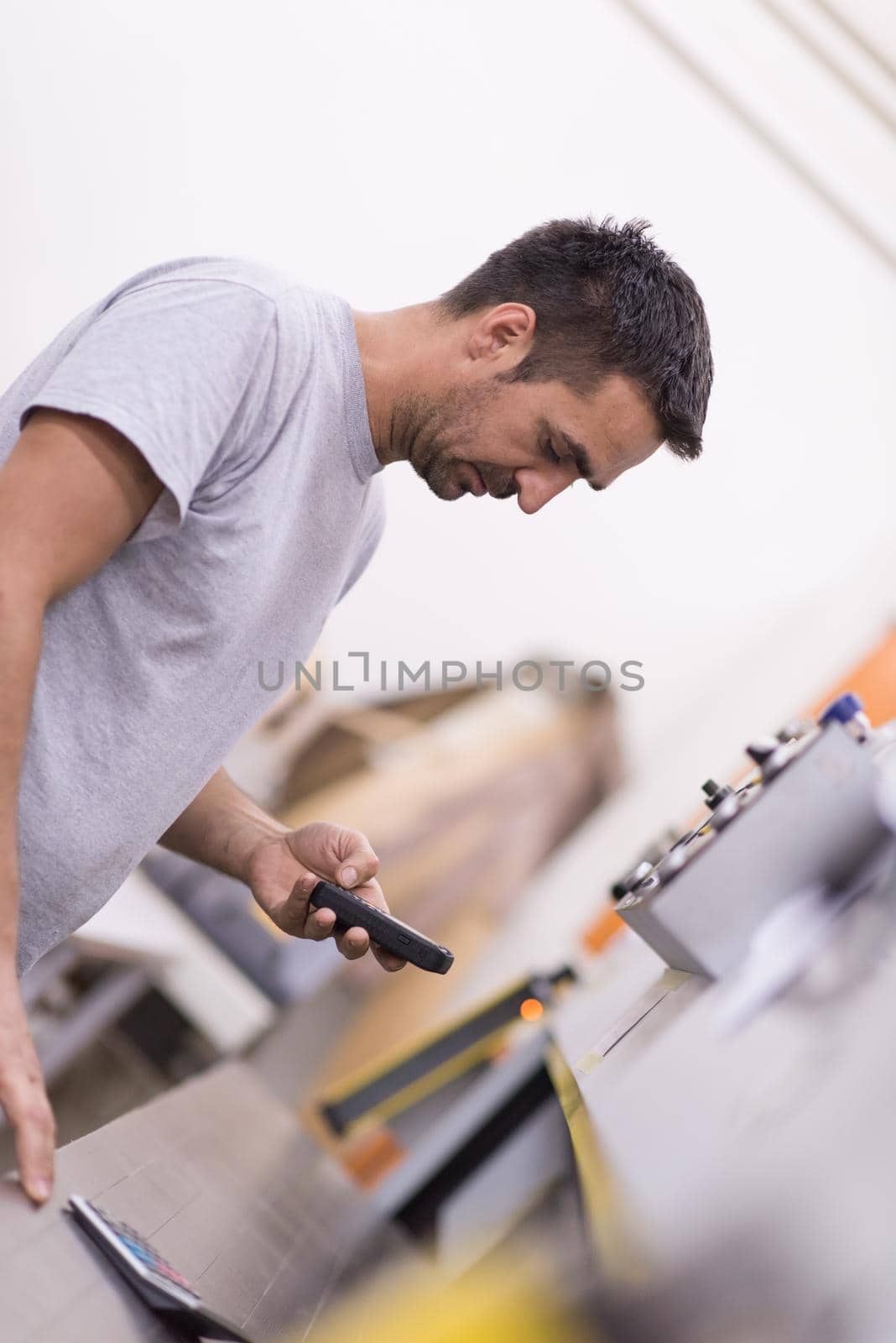engineer in front of wood cutting machine by dotshock