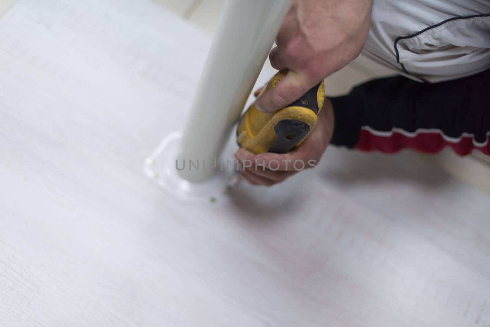 repairman working with drilling machine and assambling  furniture