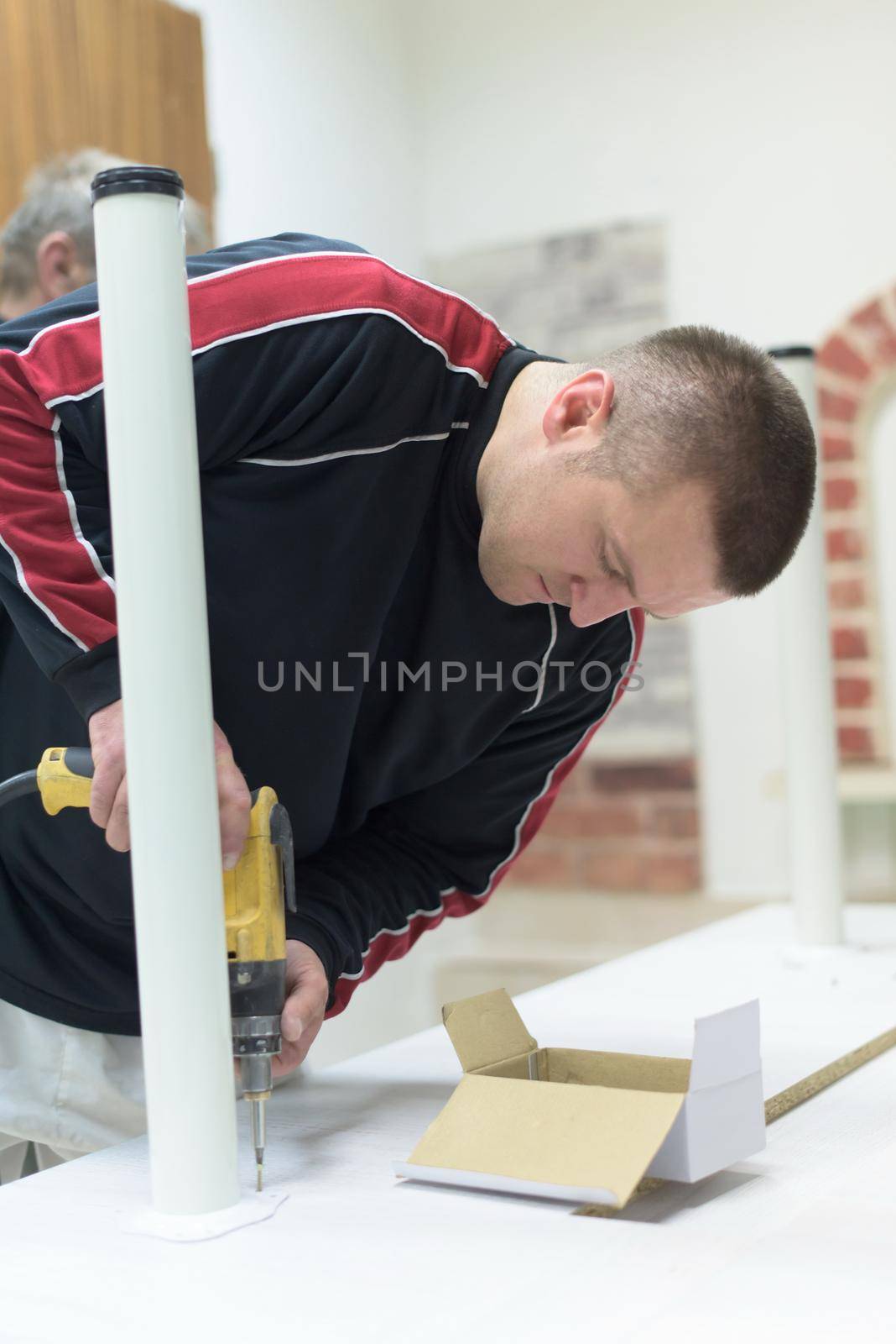 repairman working with drilling machine by dotshock